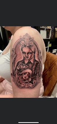 a tattoo of a woman with a skull and crossbones