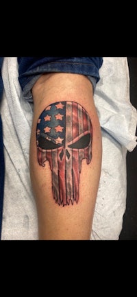 a skull tattoo with an american flag on it