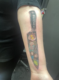 a tattoo of a kitchen knife on a person's forearm