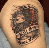 a tattoo of an opossum with the words eat trash kill god live free