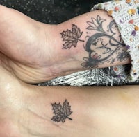a pair of wrist tattoos with leaves on them